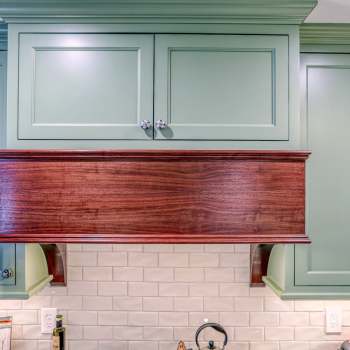 custom hood with green cabinets