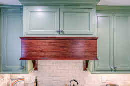 custom hood with green cabinets