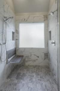 barrier free shower in grayscale with bench