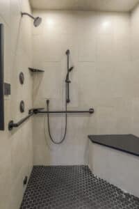 large zero free shower with black grab bars