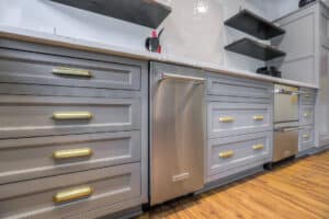 stainless steel dishwasher and cabinets with gold hardware