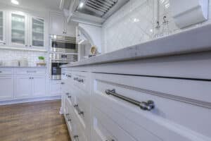 white kitchen with dark colored drawer pulls