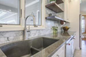 kitchen sink in gray tones with floating shelves