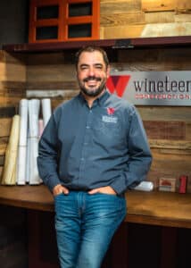 middle-aged white man standing in front of Wineteer Construction sign