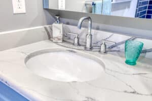 chrome faucet in bathroom with quartz countertop