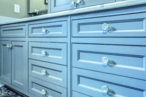 vanity with blue cabinets and glass knobs