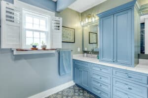 vanity and cabinets in blue in guest bathroom