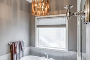 window above freestanding tub in white