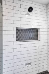 black penny tile frames in matter black edges in shower