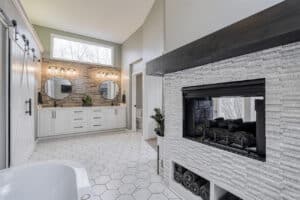 master bathroom remodel view from tub with fireplace in white marble