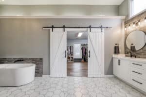 white elegant barn doors opening into master closet
