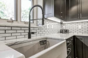 Moen sink in matte black with custom edge subway tile