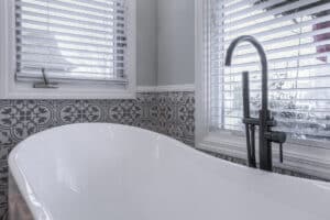 close-up of matte black faucet and fixtures on freestanding tub