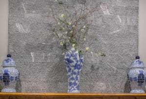 blue vases featured on fireplace mantle with jagged edges