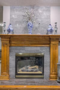 fireplace with 80's style wood and updated gray, jagged-edge tile